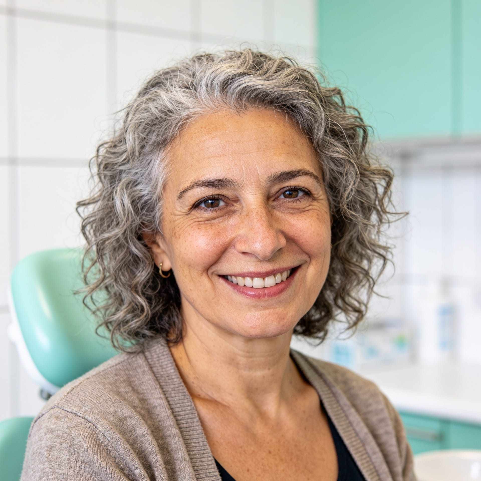 Portrait of Elena Rossi smiling, with grey curly hair